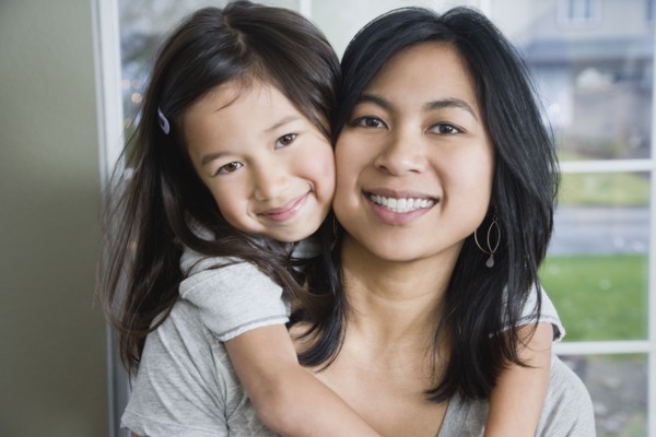 Mixed Race mother and daughter hugging