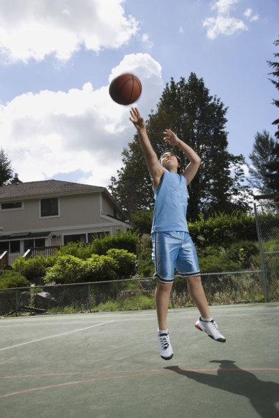 Asian boy playing basketball