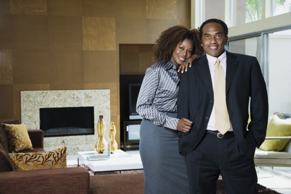 African couple standing in modern living room