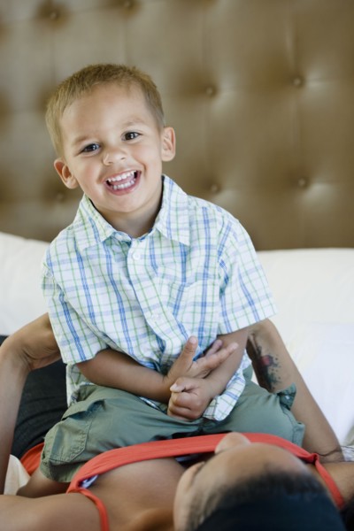 Mother and son playing on bed