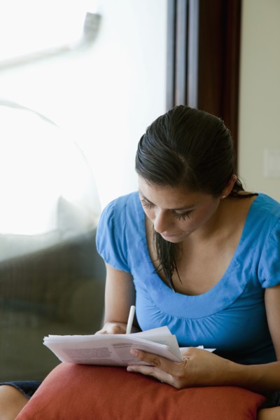 Mixed race woman filling out forms