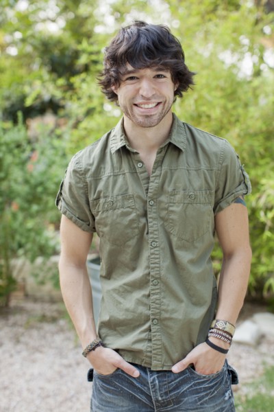 Smiling mixed race man with hands in pockets