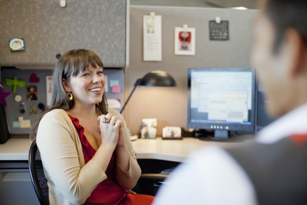 Business people talking in office cubicle