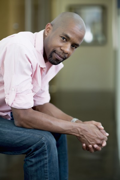 Serious Black man with hands clasped