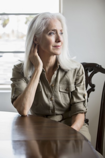 Older Caucasian woman sitting at table
