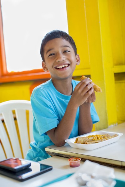 Hispanic boy eating in restaurant