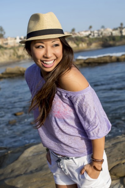 Mixed race woman smiling on beach
