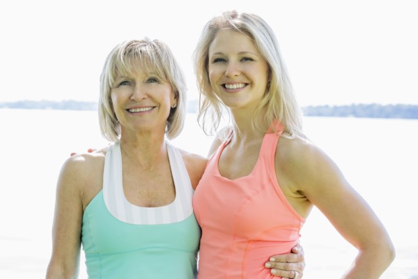 Caucasian mother and daughter smiling outdoors