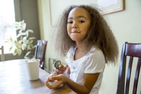 Mixed race girl enjoying hot chocolate