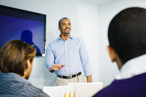 Businessman giving presentation in office meeting