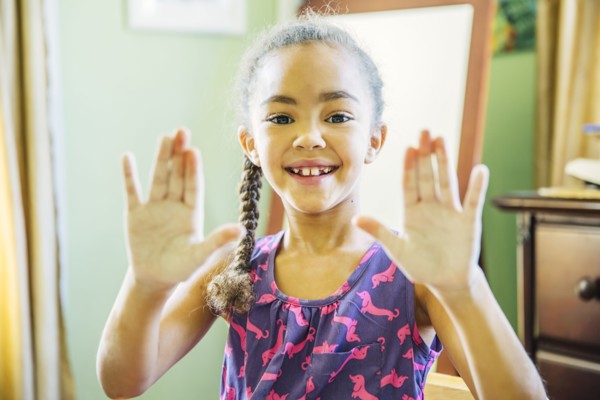 Mixed race girl showing chalky hands
