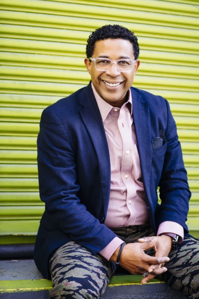 Mixed race businessman sitting at loading dock door