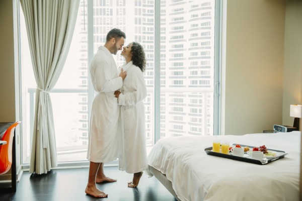 Couple hugging in bathrobes in hotel room