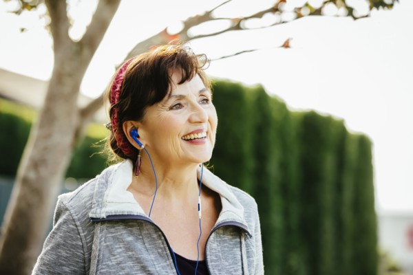 Caucasian woman listening to earbuds outdoors