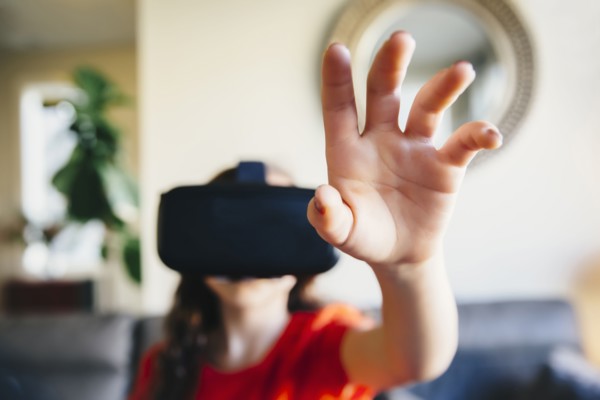 Mixed race girl using virtual reality goggles