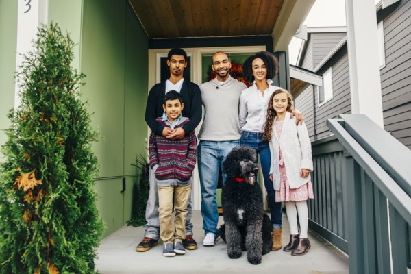 Family and dog smiling on patio