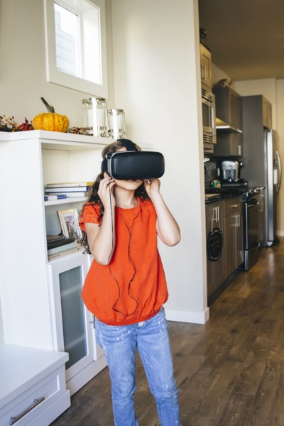 Mixed race girl using virtual reality goggles