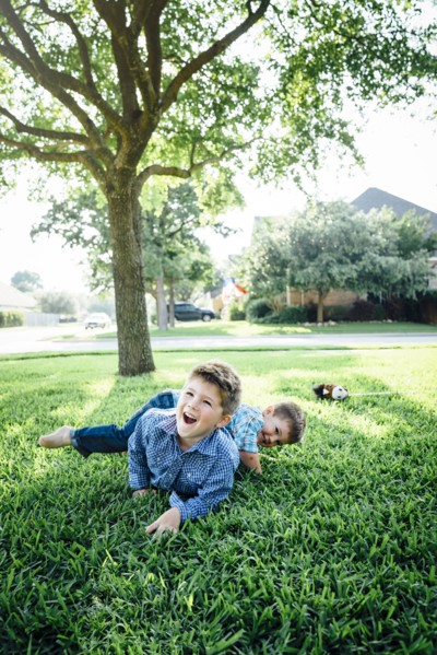 Smiling Caucasian boys playing in grass