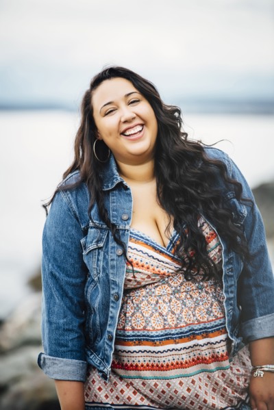 Smiling Mixed Race woman near ocean