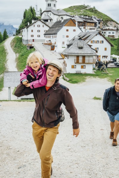 Caucasian father carrying daughter