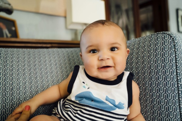 Portrait of smiling Mixed Race baby boy on chair