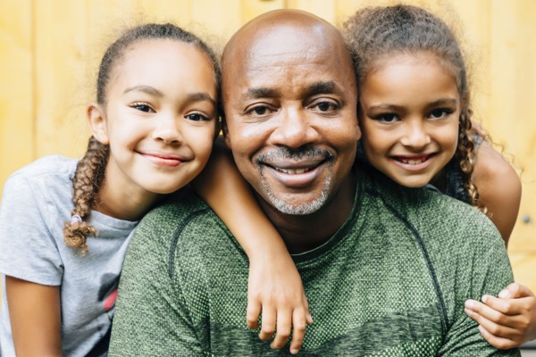 Portrait of smiling father and daughters