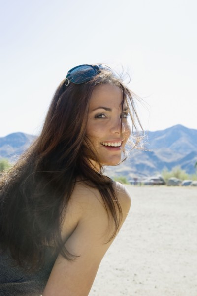 Hispanic woman with sunglasses smiling