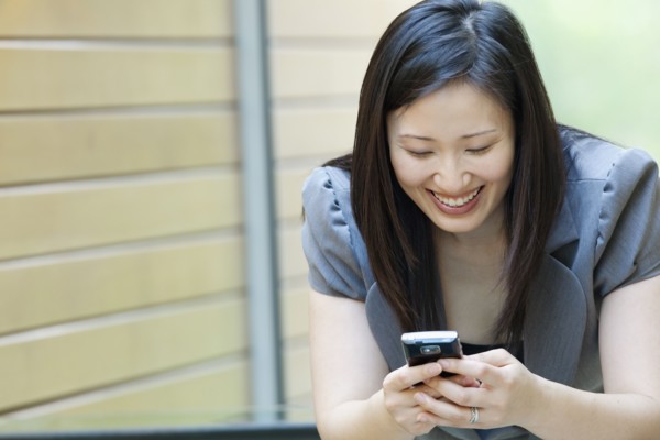 Asian businesswoman looking at cell phone