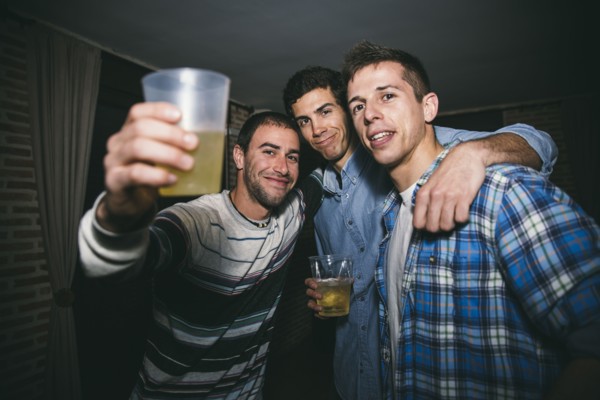 Smiling men drinking in nightclub