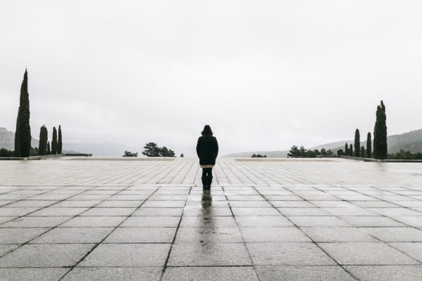 Caucasian woman walking in concrete courtyard