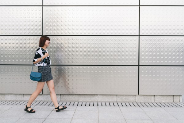 Chinese woman walking on sidewalk