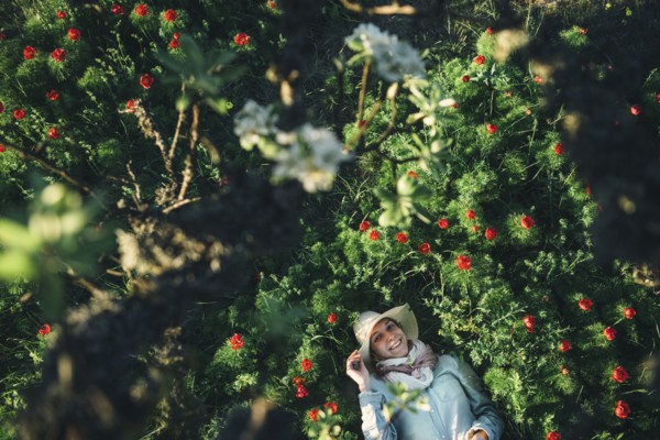 Smiling Caucasian woman laying in flowers