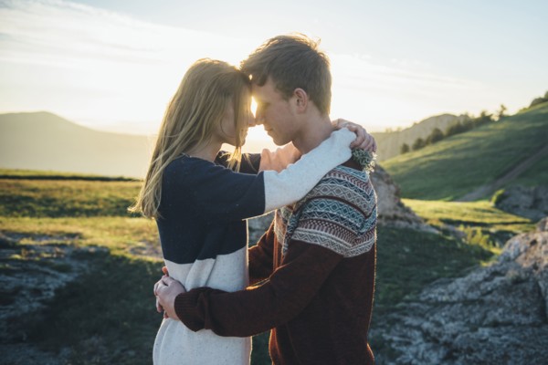 Caucasian couple rubbing noses and hugging