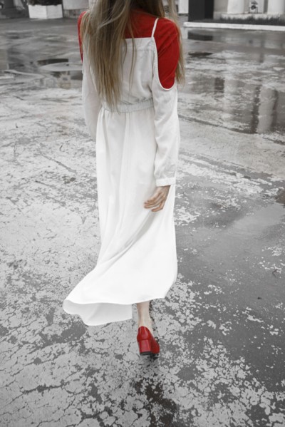 Rear view of Caucasian woman walking in rain