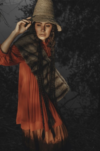 Caucasian woman wearing traditional clothing at night