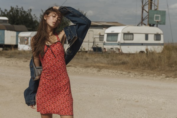 Frustrated Caucasian woman standing near trailers