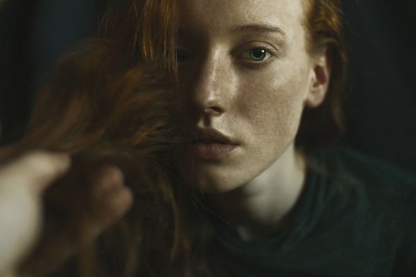 Caucasian woman holding hair
