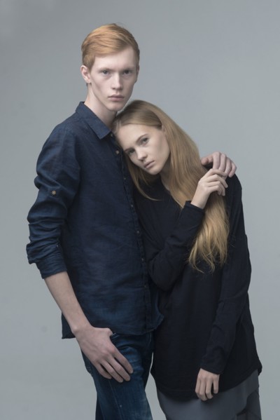 Portrait of serious Caucasian couple hugging