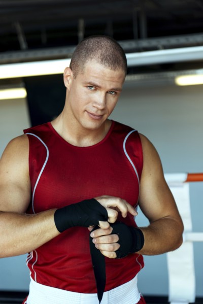 Caucasian boxer wrapping hands