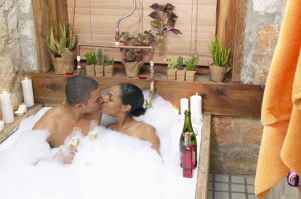 Couple in bubble bath kissing