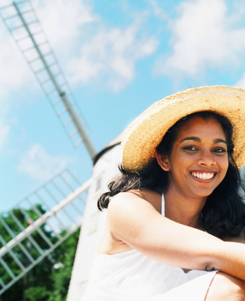 Young woman smiling with sun hat