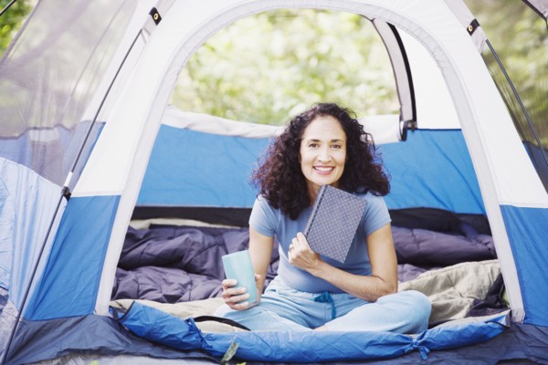 Woman with coffee in tent