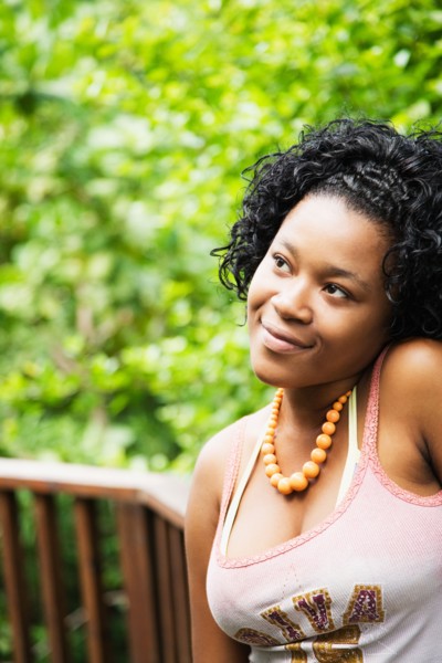 African woman looking pensive on patio