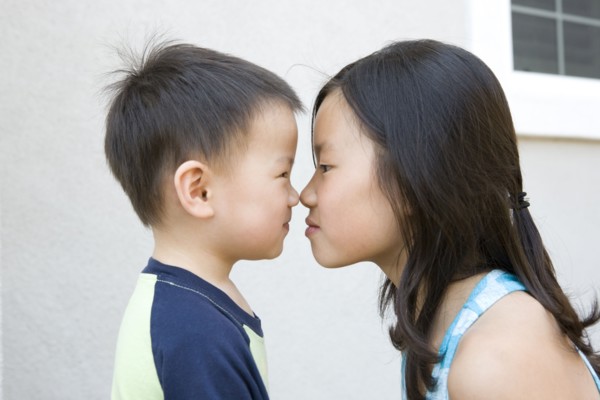 Chinese brother and sister staring at one another