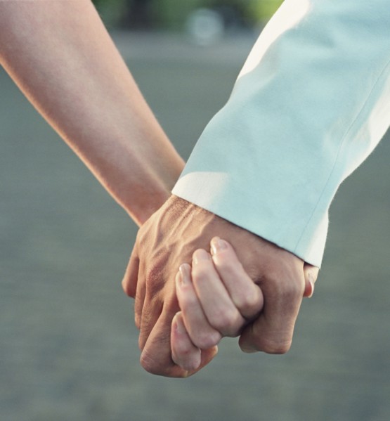 Close up of couple holding hands