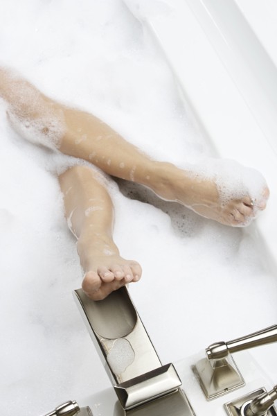 Caucasian woman relaxing in bubble bath