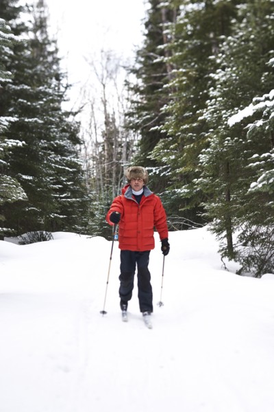 Caucasian man cross country skiing in snowy landscape