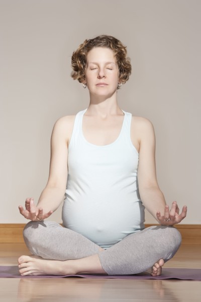 Caucasian pregnant woman meditating