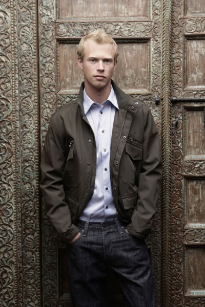 Caucasian man standing at ornate door