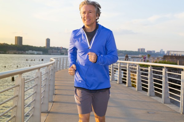 Caucasian man jogging on urban waterfront